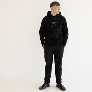 Harry wearing a black hoodie and pants on a white background